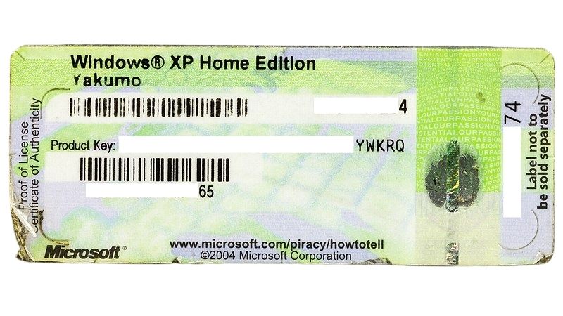 Image of a paper Microsoft XP Home Edition License from 2004. This key injects a digital Windows license.
