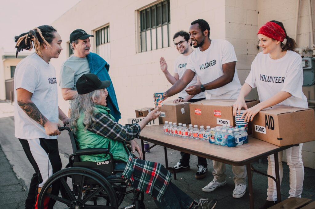 Charitable organization giving to a woman in a wheelchair. Charities are eligible for Windows citizenship licenses